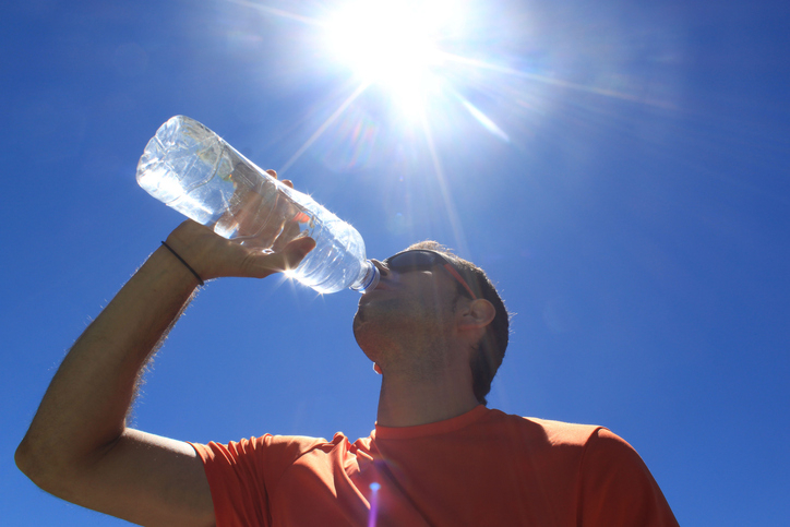 Man drinking water on a hot day